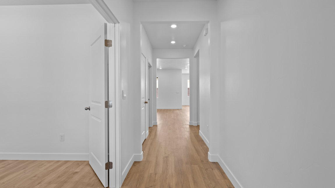private office opening up to an extra wide hallway leading to additional living space