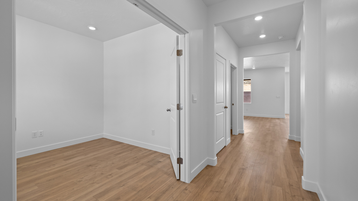 private office opening up to an extra wide hallway leading to additional living space