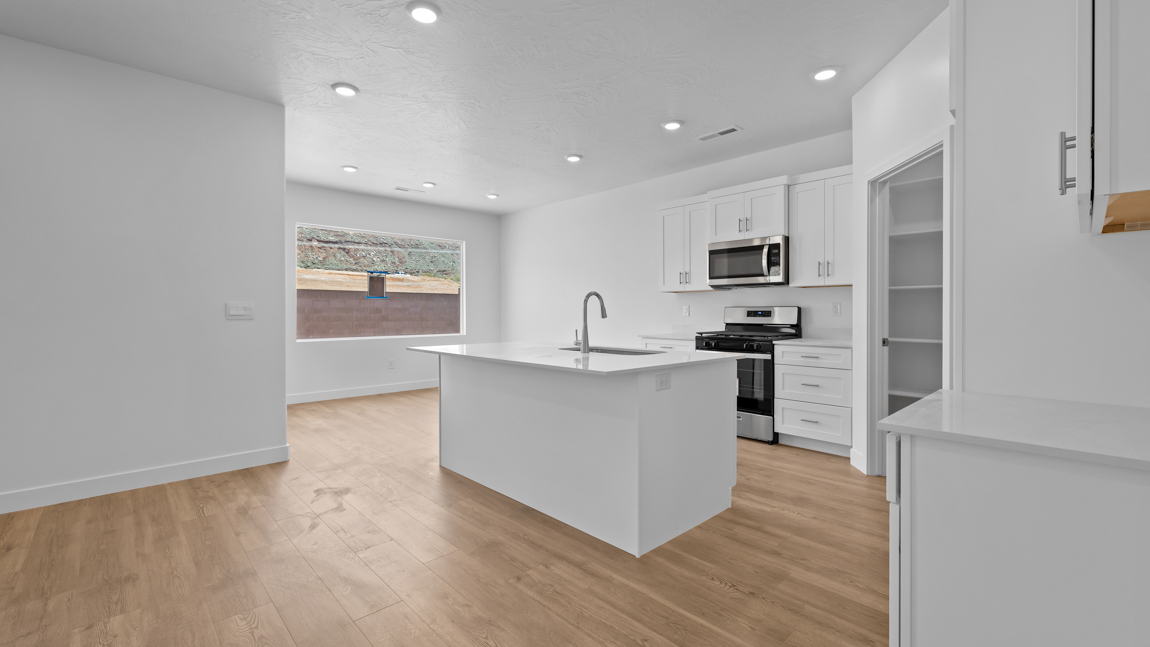 Large living room and adjoining kitchen and dining room with large picture windows