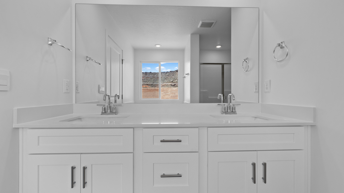 Large primary bathroom with quartz countertops, double sink vanity, and separate walk in shower and garden tub with window