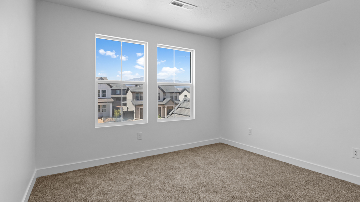 Spacious bedroom with large bright window
