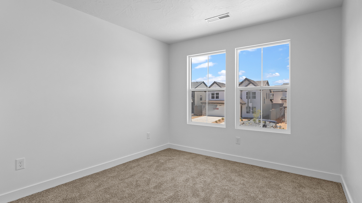 Spacious bedroom with large bright window
