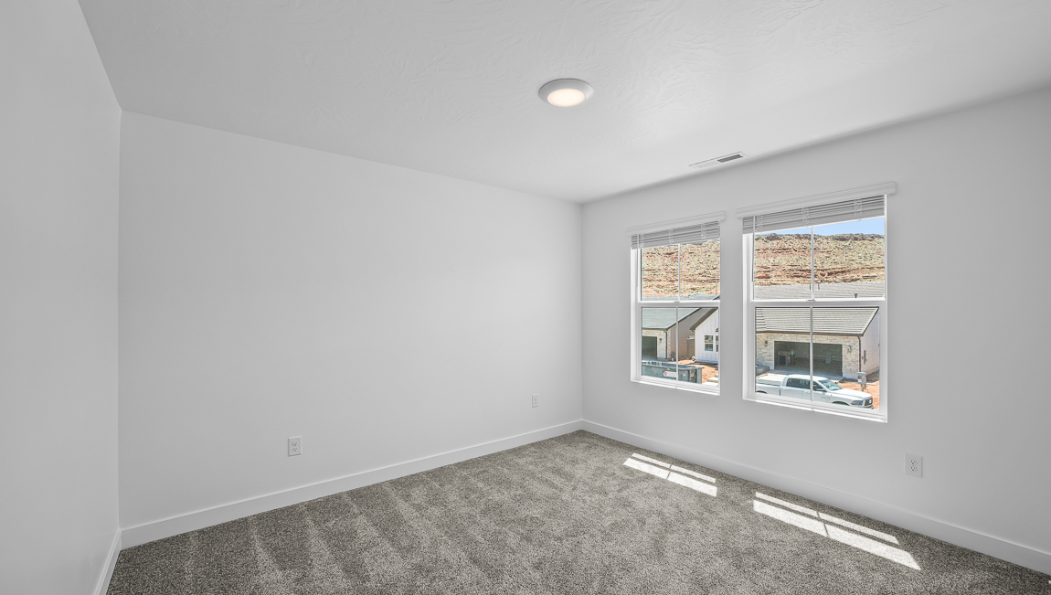 Spacious bedroom with large bright window
