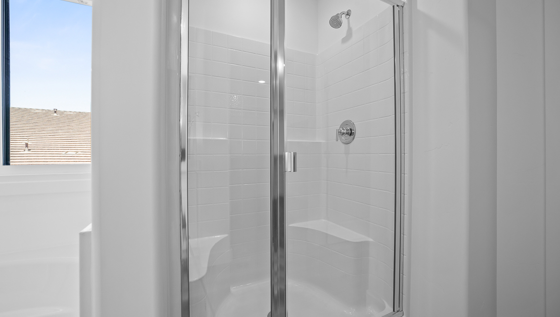 Primary bathroom walk in shower with glass surround