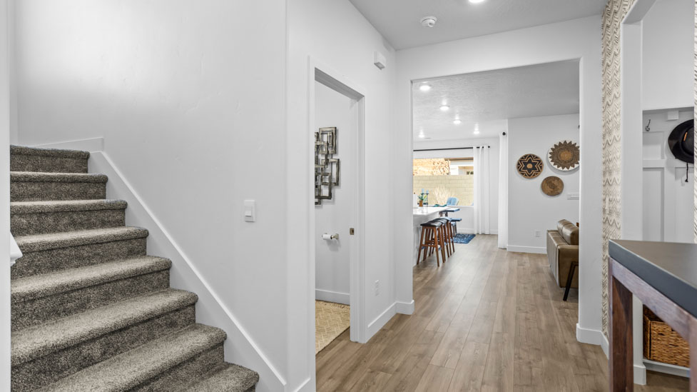 Entry with wide hallway and stairs leading to the upper floor