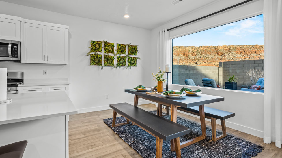 Dining room area with large picture window and premium laminate flooring