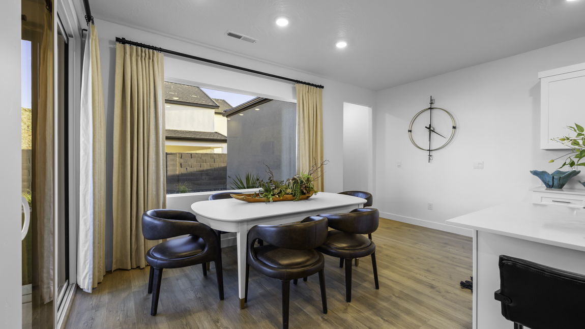 Dining room area with large picture window and premium laminate flooring