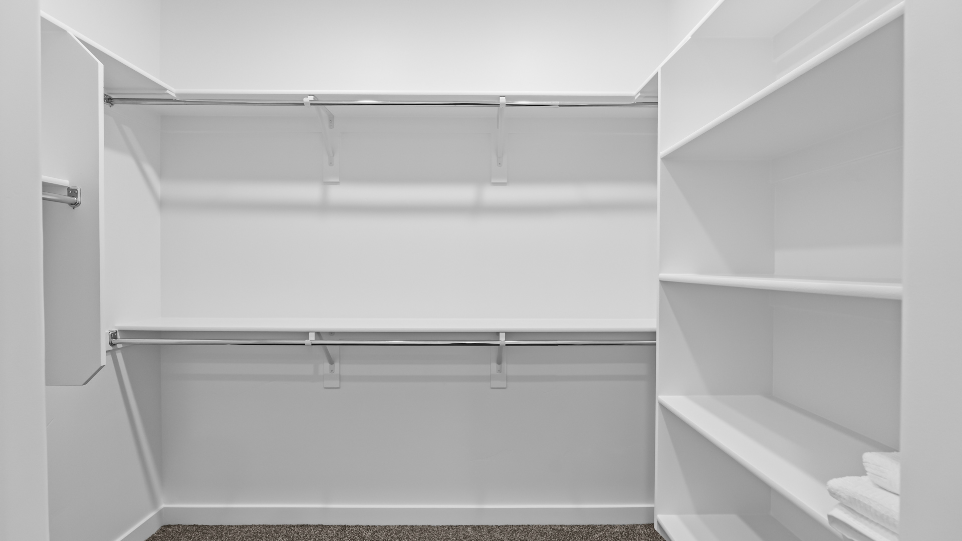 Spacious walk in closet with built in storage shelving