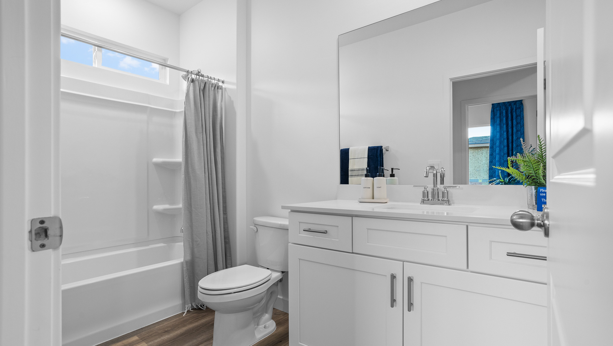 Secondary bath with quartz countertops and tub shower combo