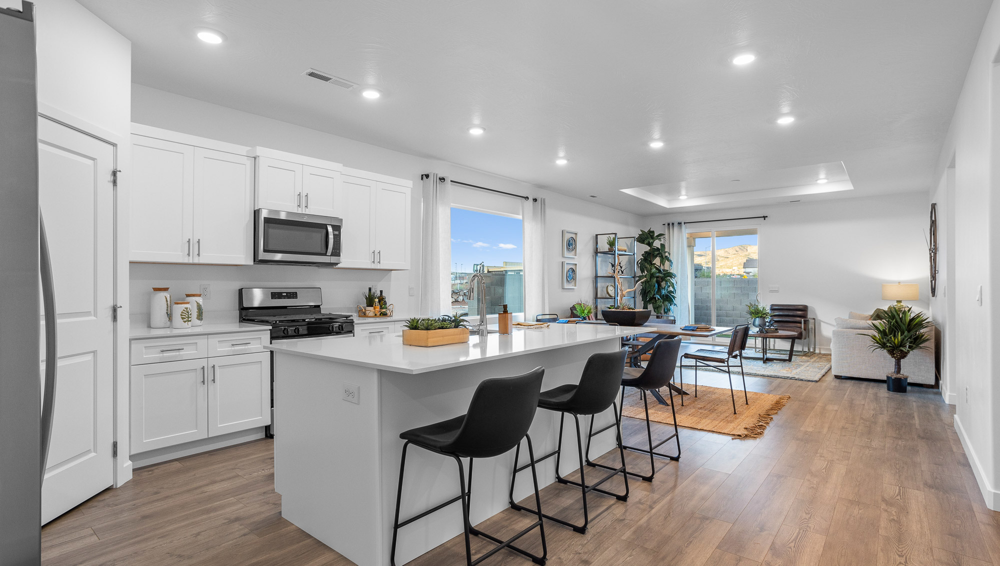 Spacious kitchen with quartz countertops, island, opening to the dining room