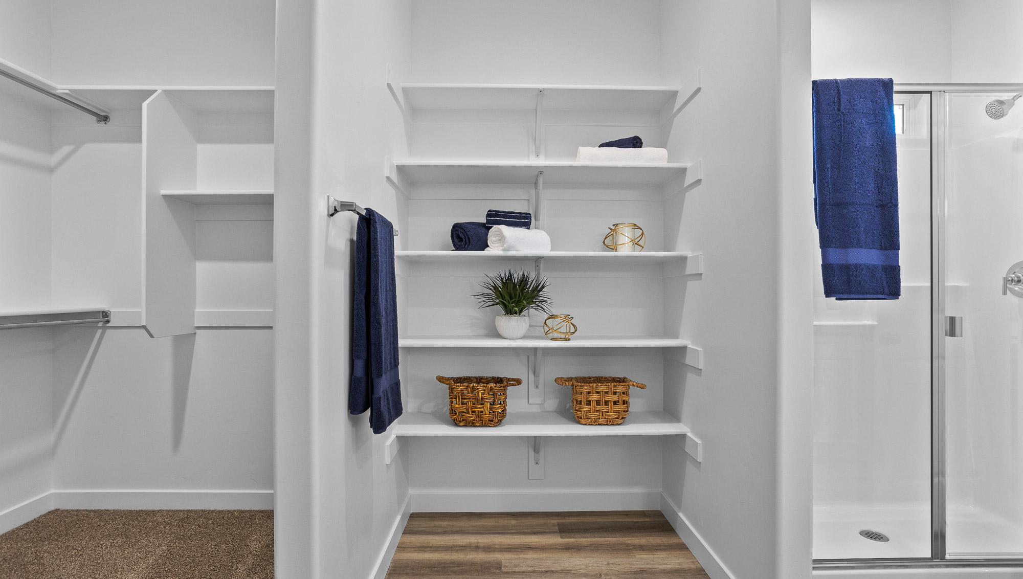 Spacious walk in closet with built in storage shelving