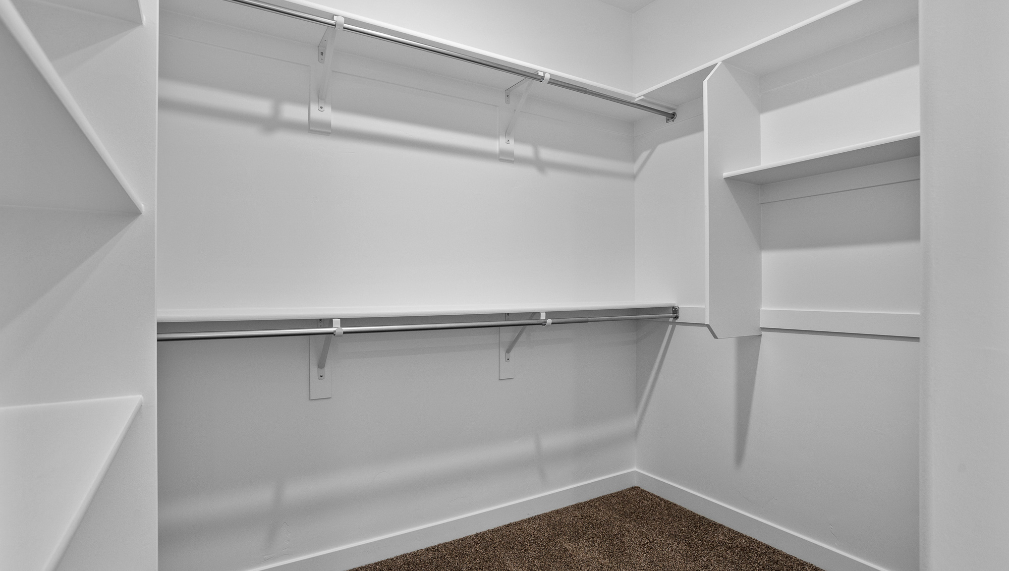 Spacious walk in closet with built in storage shelving