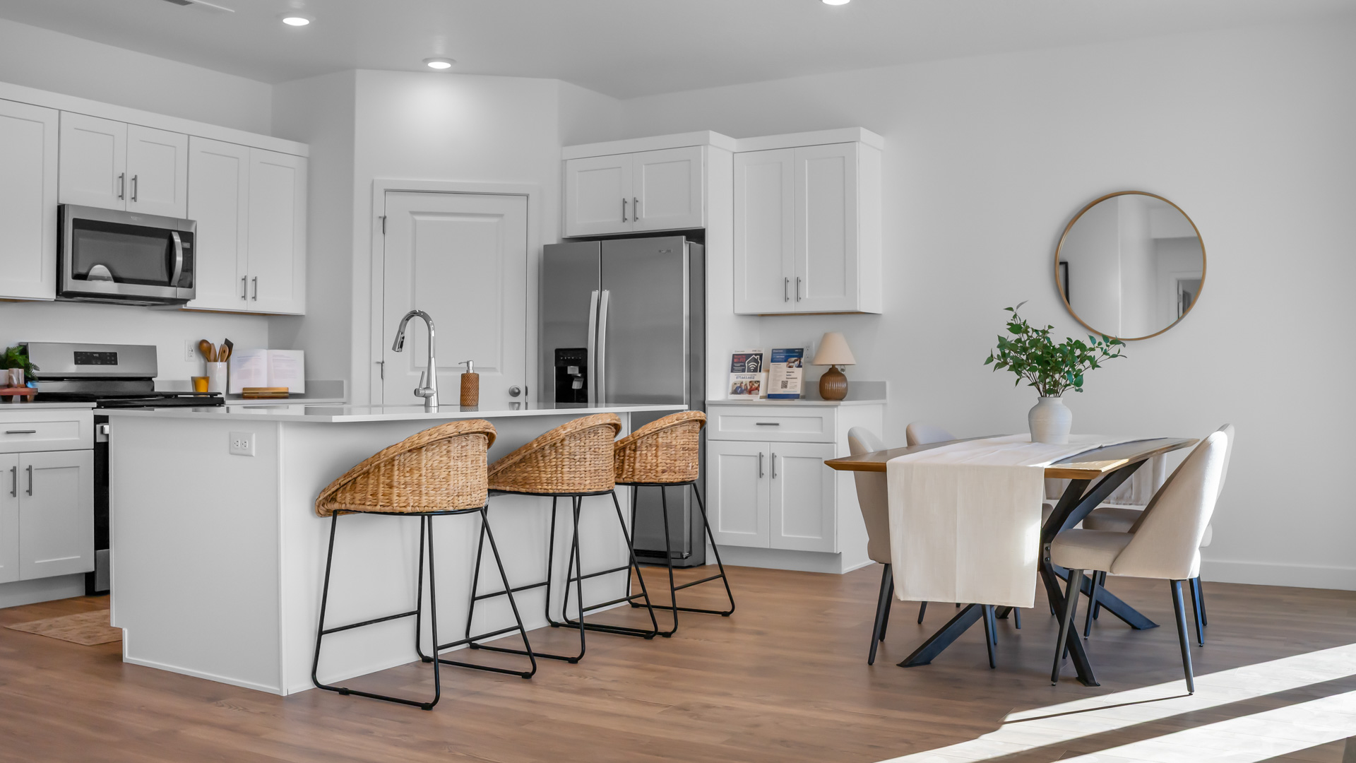Kitchen area with kitchen sink at island, cabinets, and stainless steel appliances.