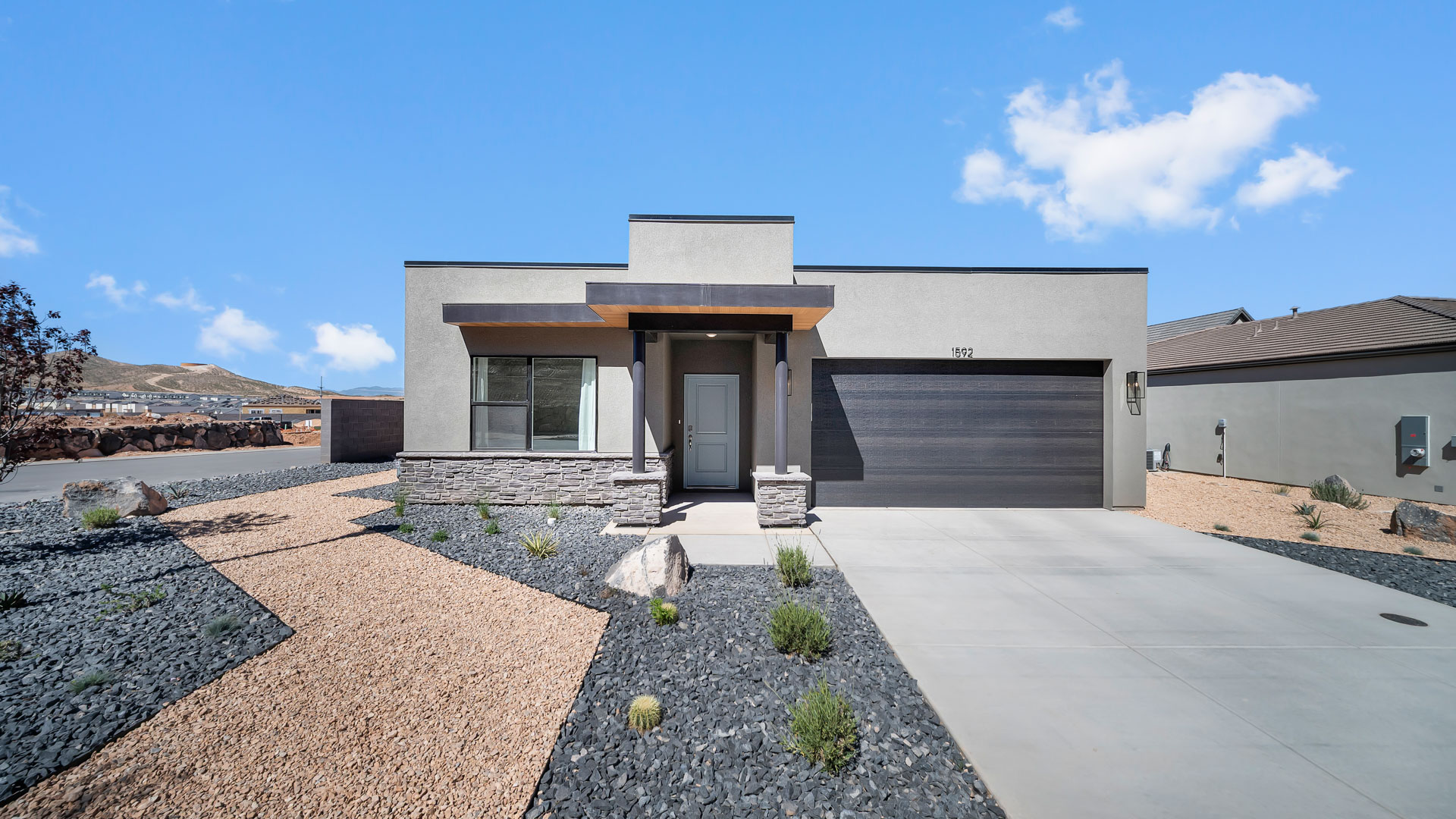 brand new single story home in St George with a desert style exterior and two car garage