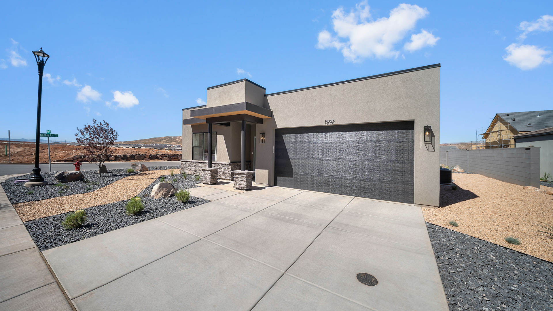 brand new single story home in St George with a desert style exterior and two car garage