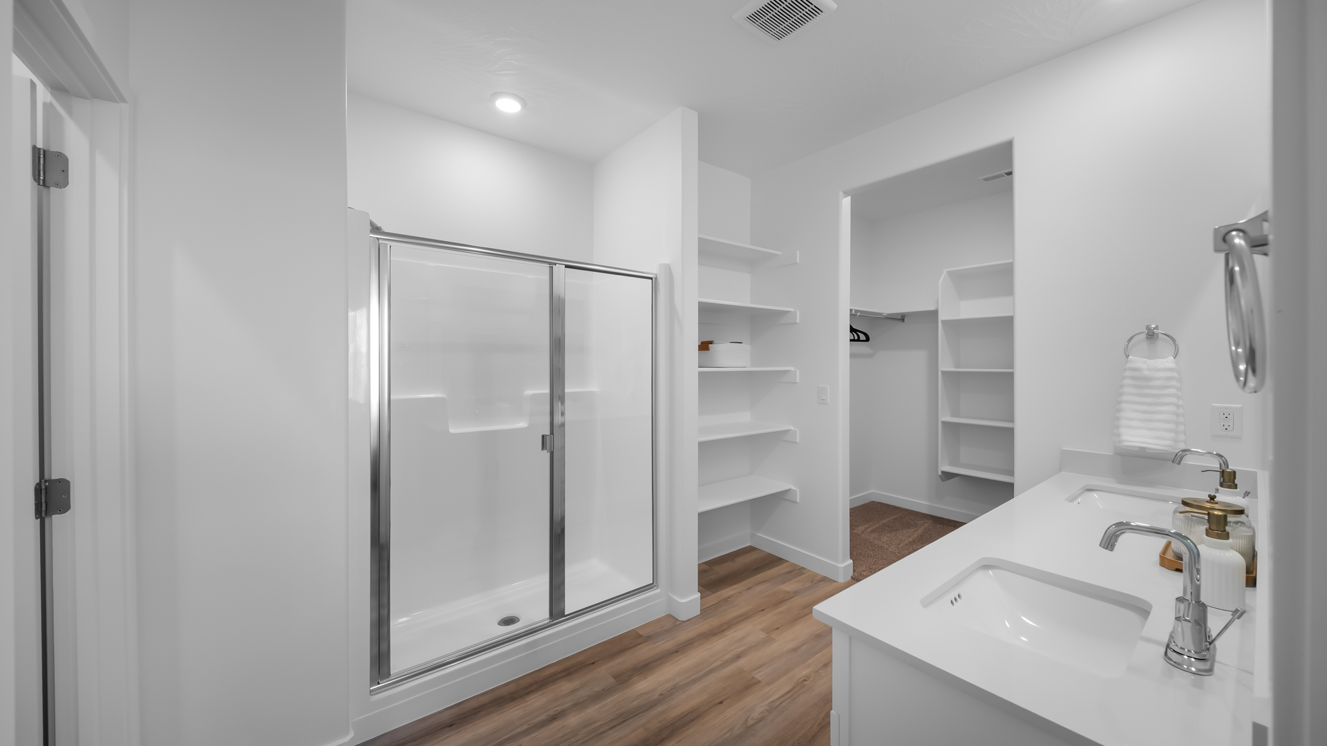 Primary bathroom with double sink vanity, shower, and water closet.