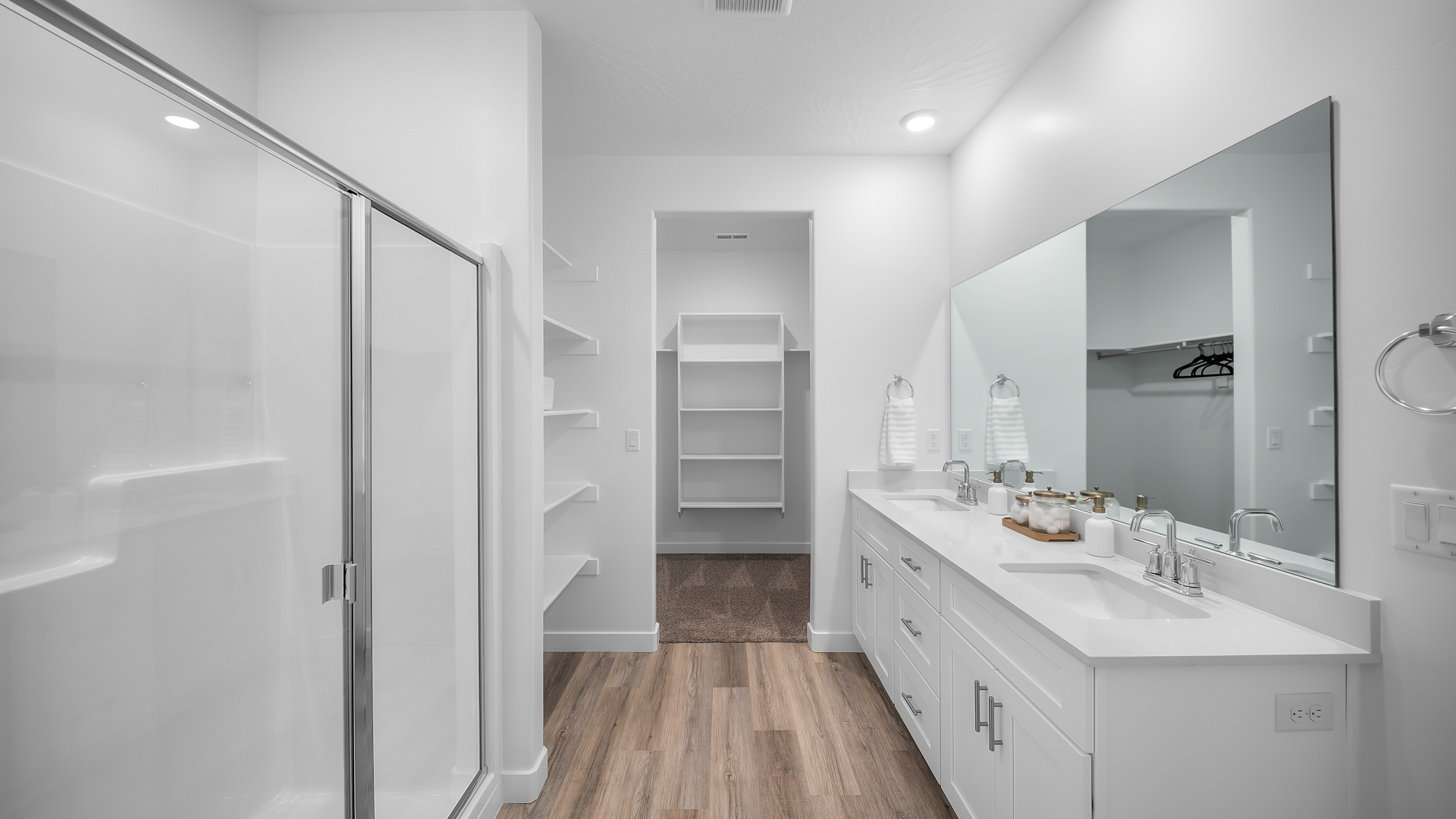 Primary bathroom with double sink vanity, shower, and water closet.