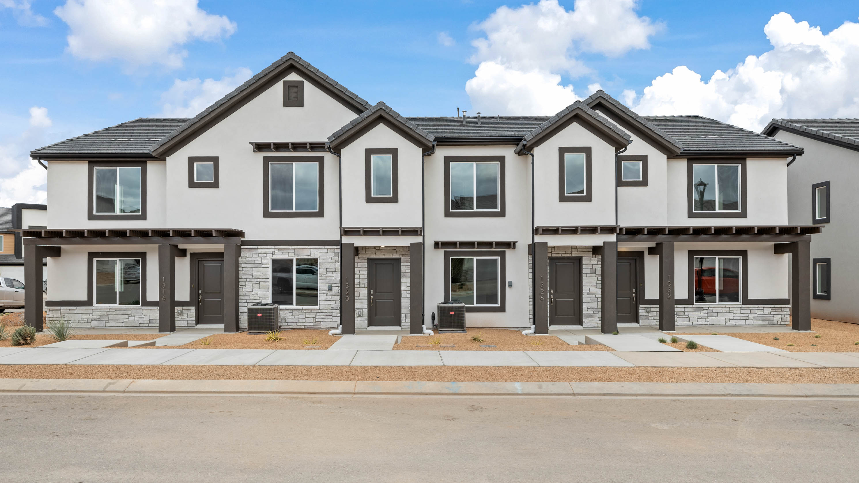 new townhomes in Washington with a desert traditional exterior with white stucco and dark brown trim
