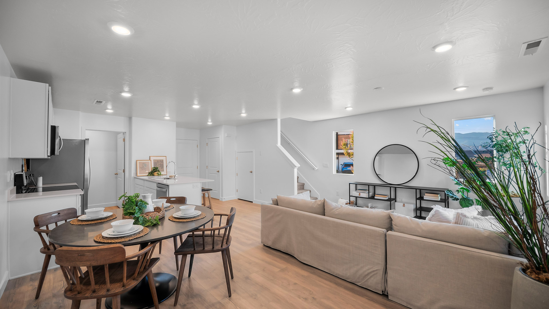 Bright open first floor which includes family room, dining space, and kitchen with quartz countertops