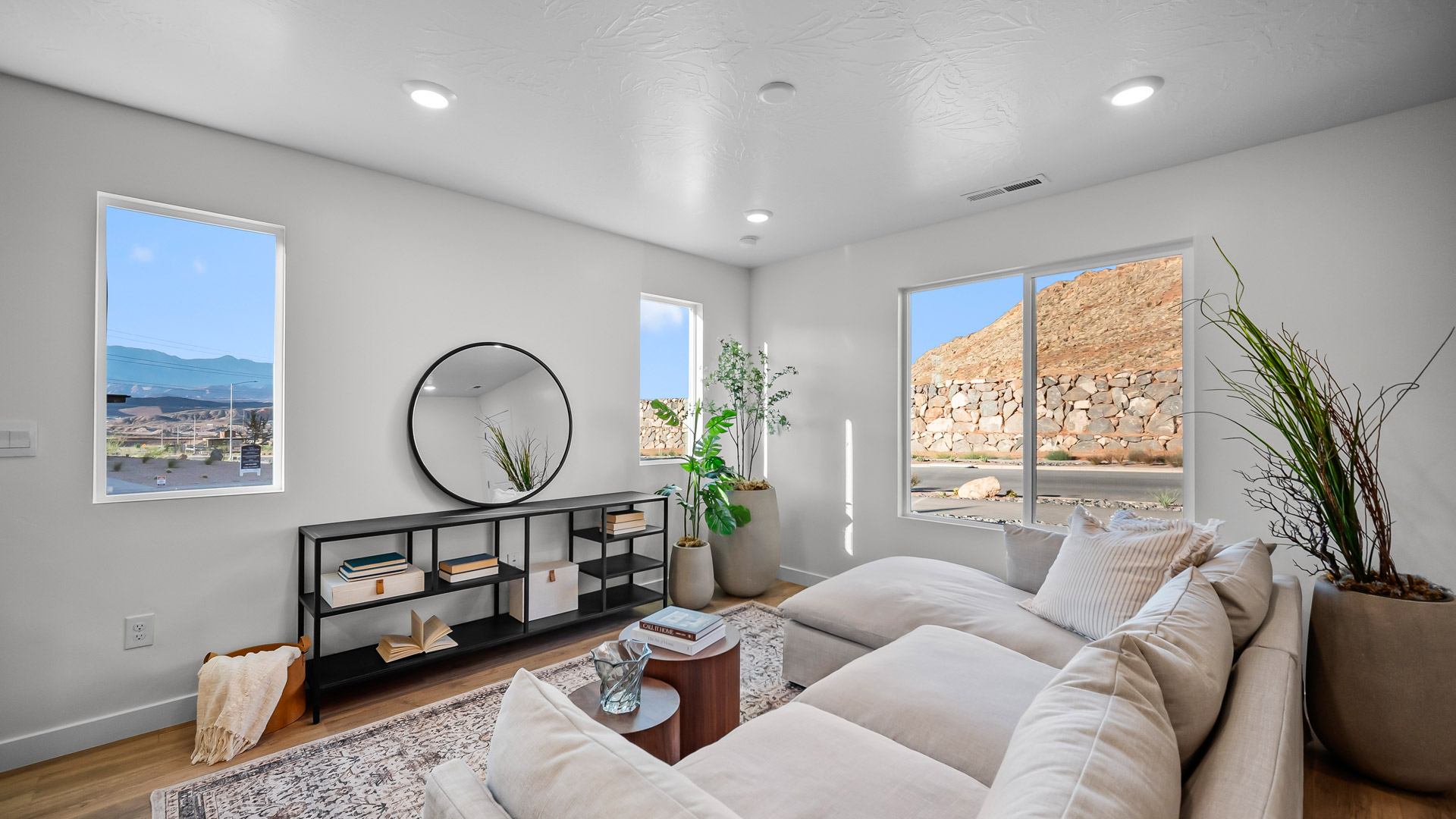 Large open living room with oversized windows and premium laminate flooring