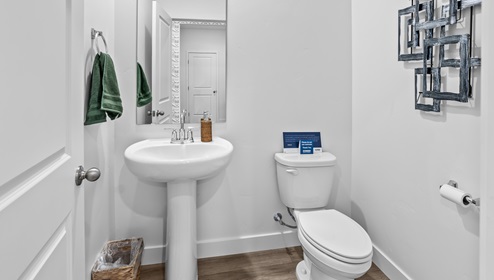 Main floor conveniently placed powder room with pedestal sink.