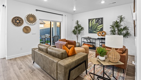 Step into the open concept main floor living area with a sliding glass door leading out to the patio of the Stillwater home.
