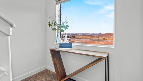 At the middle point of the stairs going up to the second level of the home is a large window greeting you with light.