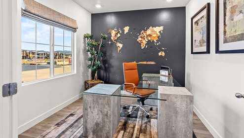 Inside the Stillwater single family home is a bedroom turned office flex room with a large window gracing it with warm sunlight.