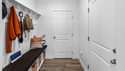 Convenient mudroom with beautiful built in storage spaces and hooks in the Stillwater model home in Long Valley.