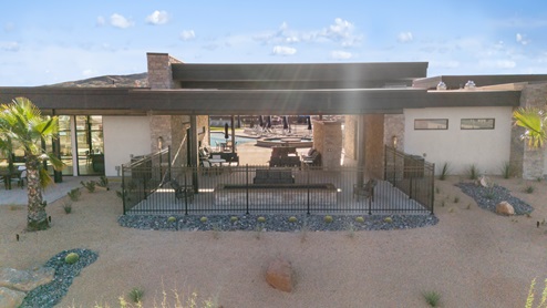 An outside aerial look focusing on the Long Valley clubhouse shaded fire pit entertaining area.