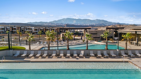 Palm tree lined pool areas with lounge chairs for all at the Long Valley community in Washington Utah.