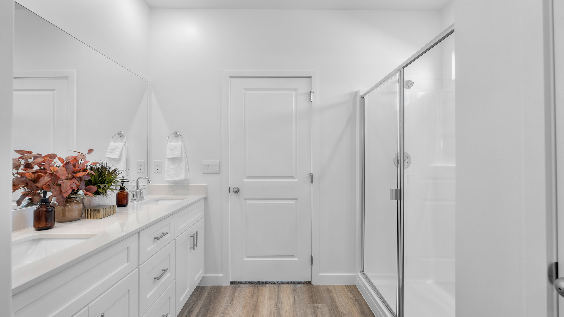 Primary bathroom with dual vanity and walk in shower