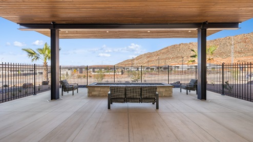 Long Valley clubhouse outdoor shaded lounge area with fire pit for outside entertaining.