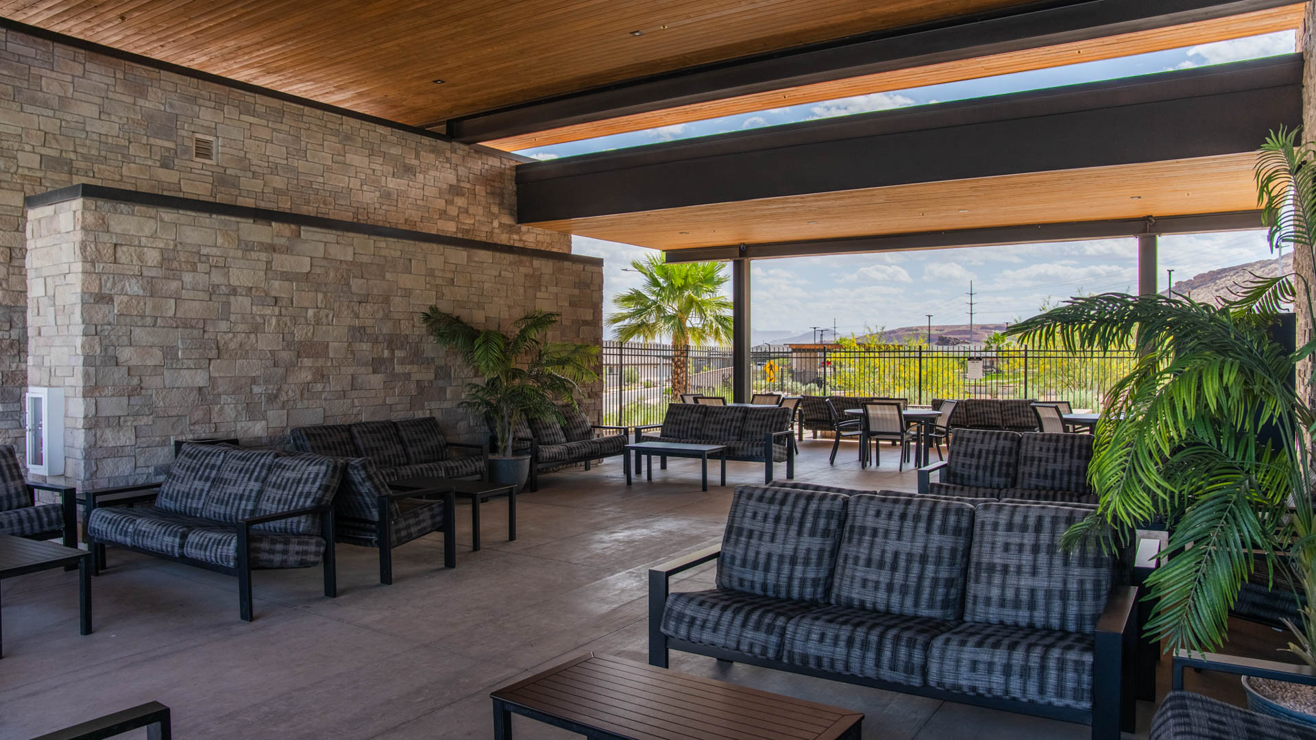 An outside look focusing on the Long Valley clubhouse shaded fire pit entertaining area.