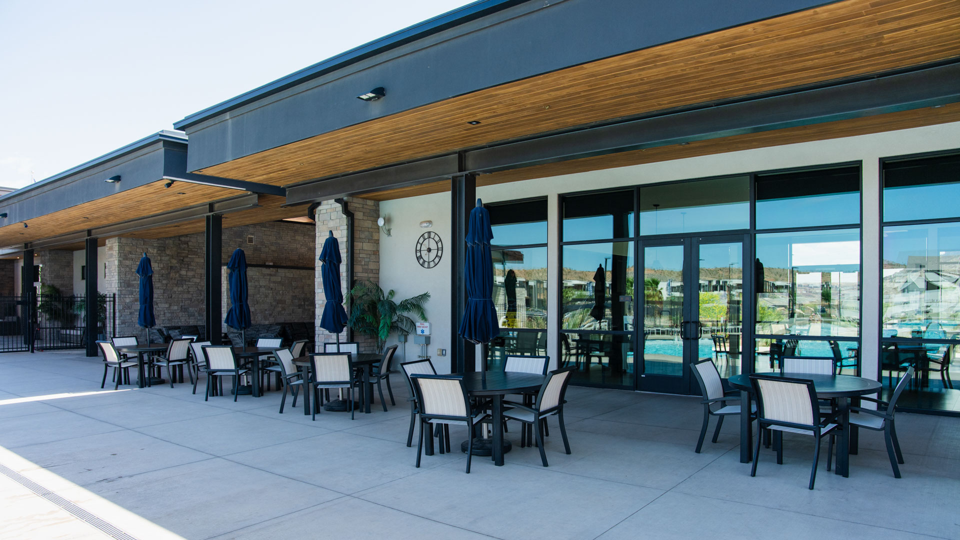 An outside aerial look focusing on the Long Valley clubhouse shaded fire pit entertaining area.
