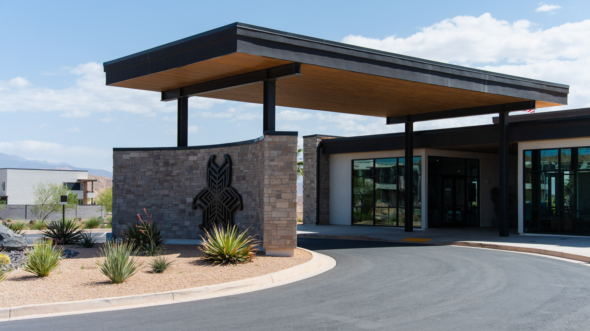 Lower Aerial view of the Long Valley community entrance sign in front of the expansive and stylish clubhouse.