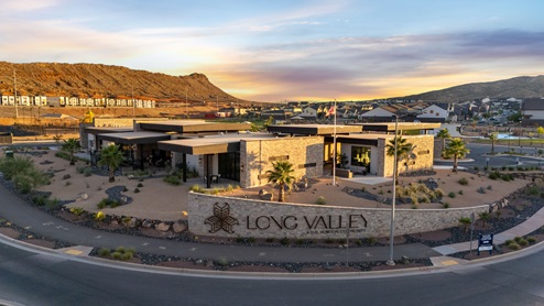 Lower Aerial view of the Long Valley community entrance sign in front of the expansive and stylish clubhouse.