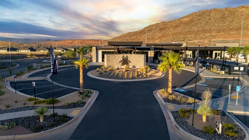 Lower Aerial view of the Long Valley community entrance sign in front of the expansive and stylish clubhouse.