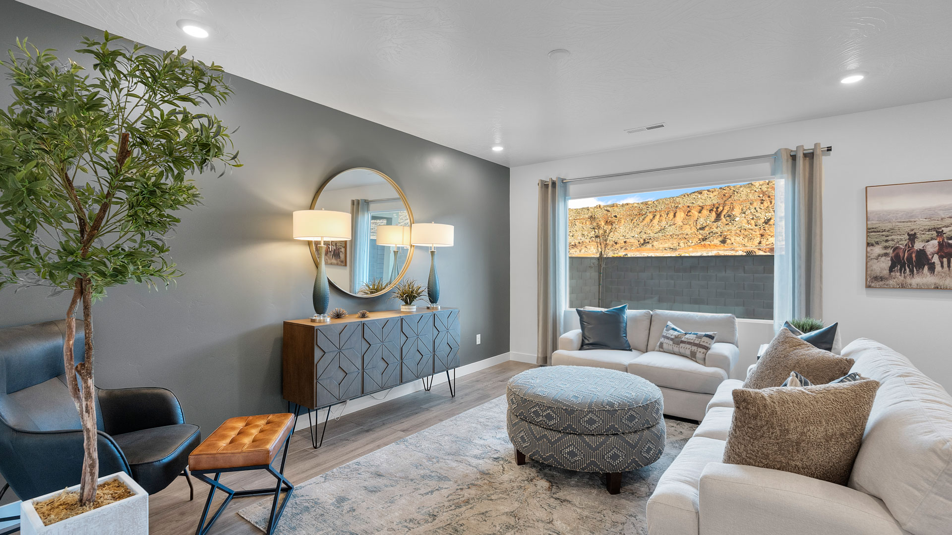 Large family room with oversized window, premium laminate flooring, and a sliding glass door going to the backyard