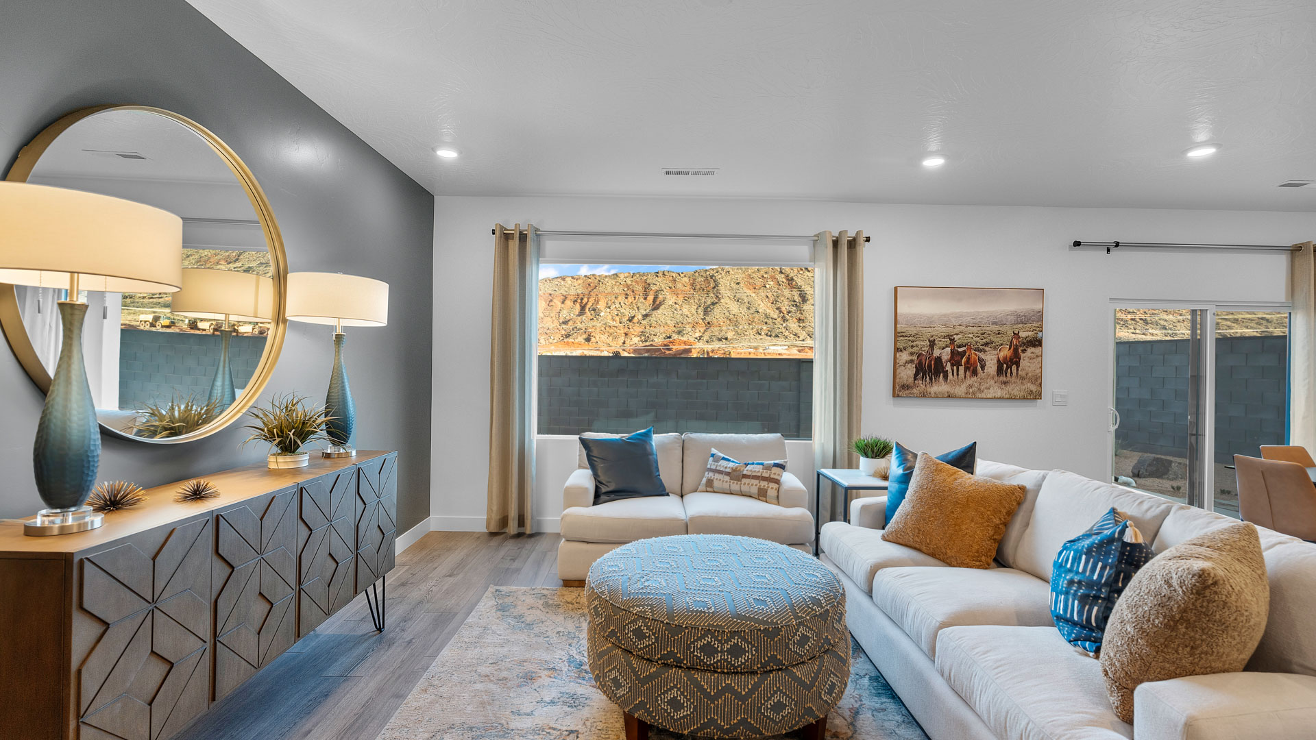 Large family room with oversized window, premium laminate flooring, and a sliding glass door going to the backyard