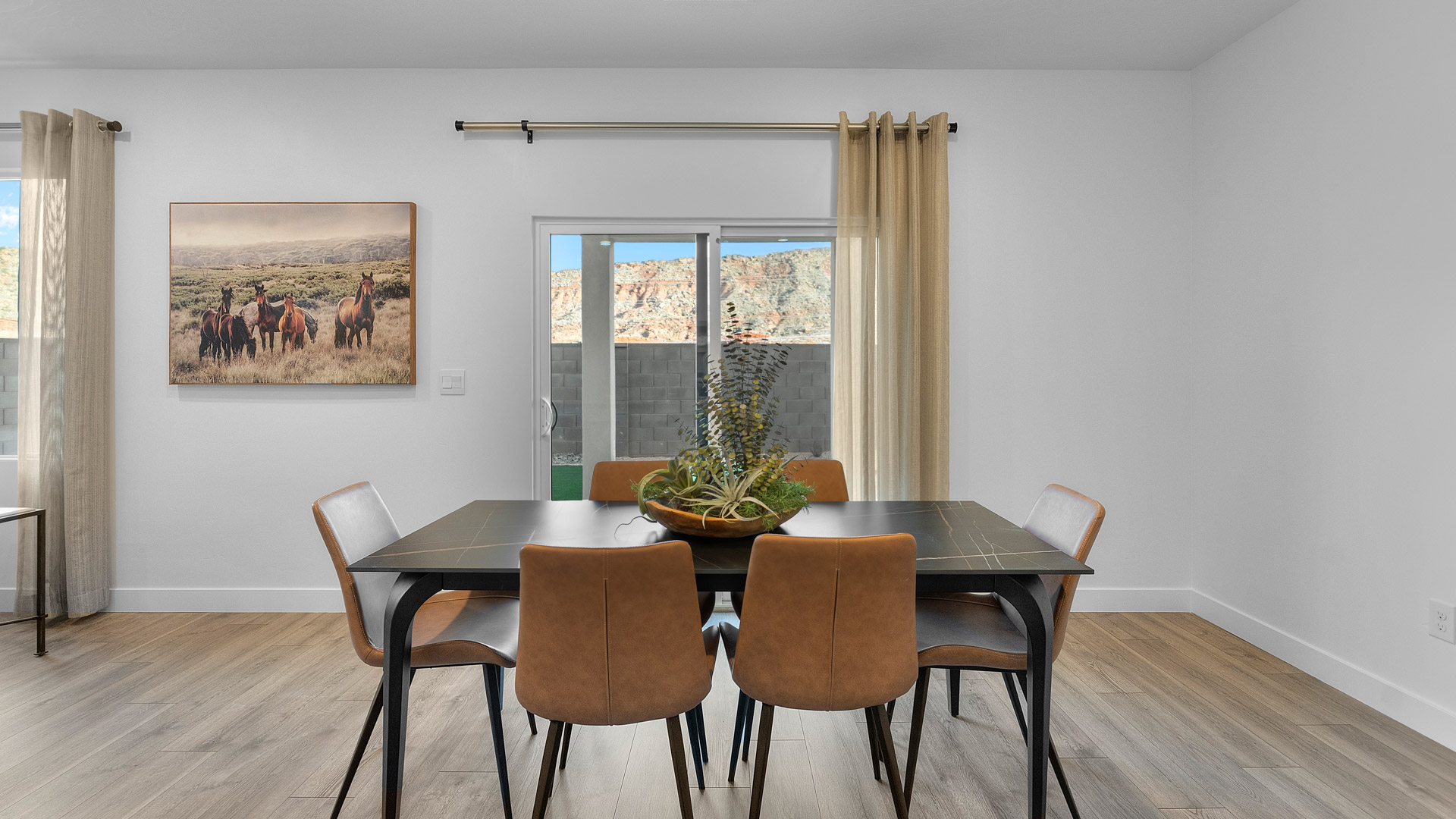 View of dining room with sliding glass door out to backyard, spacious kitchen with an in breakfast bar sink, stainless steel appliances
