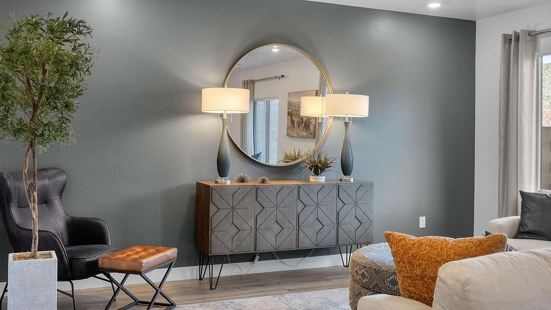 Large family room with oversized window, premium laminate flooring, and a sliding glass door going to the backyard