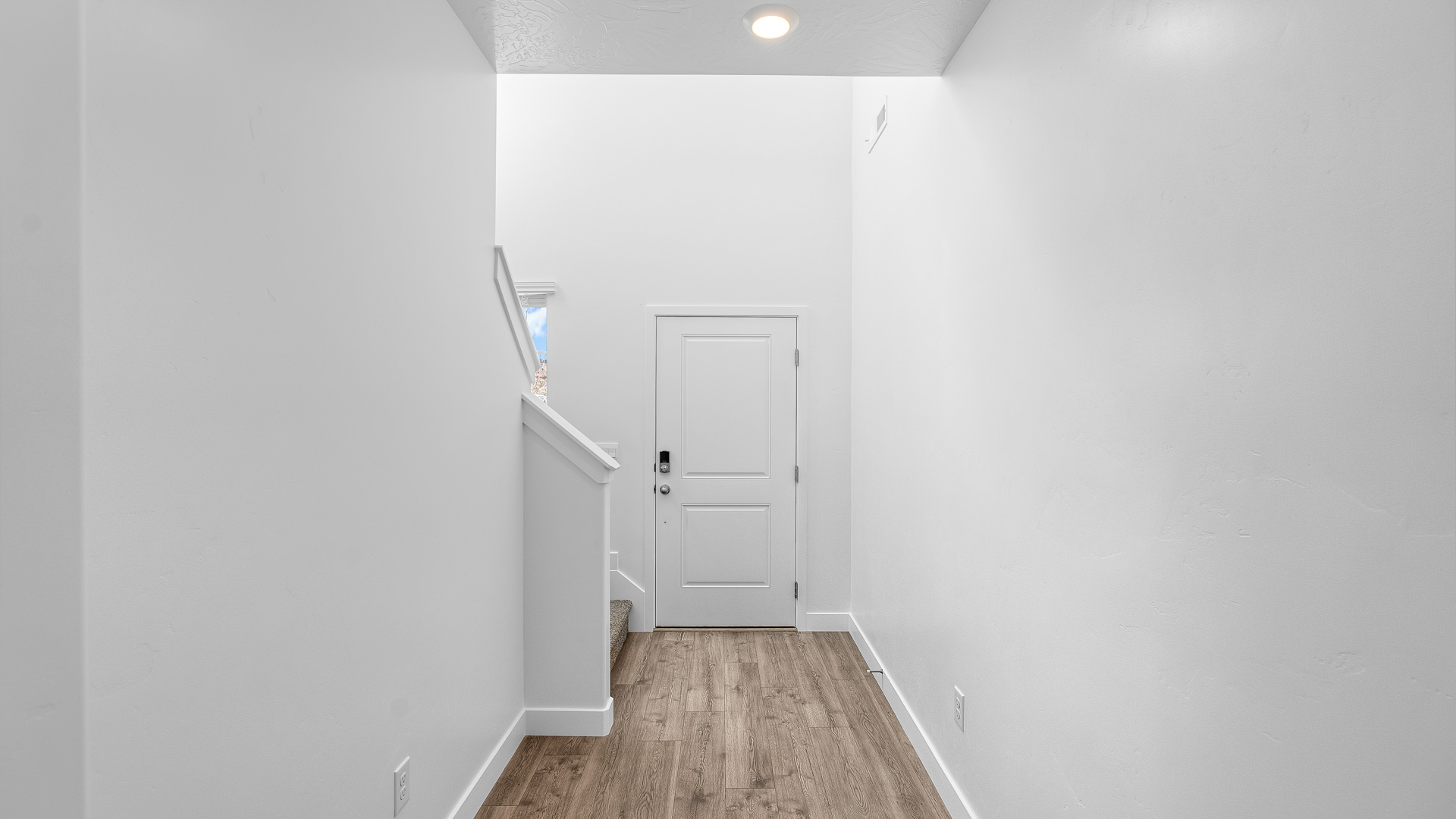 Spacious entryway featuring stairs.