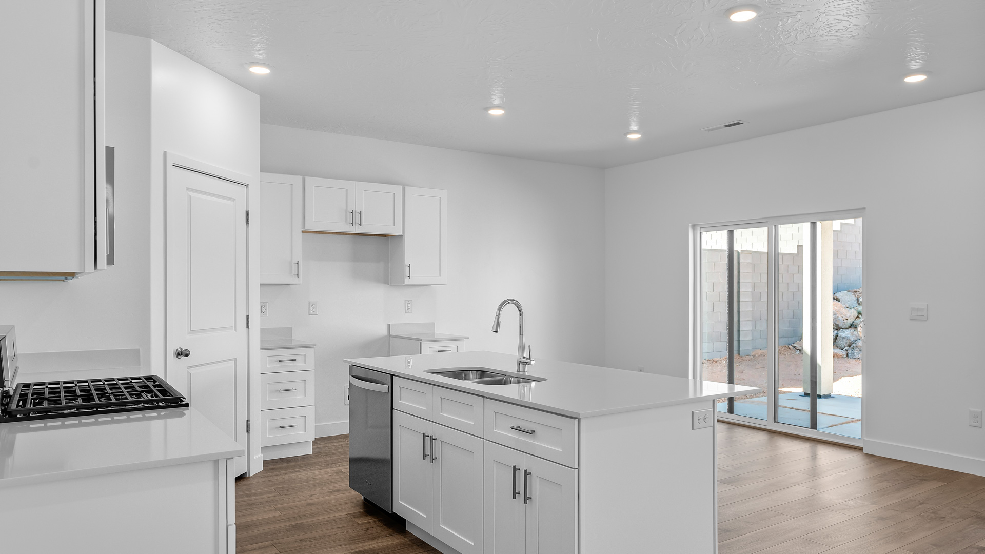 Kitchen space with kitchen island and white cabinets and countertops.