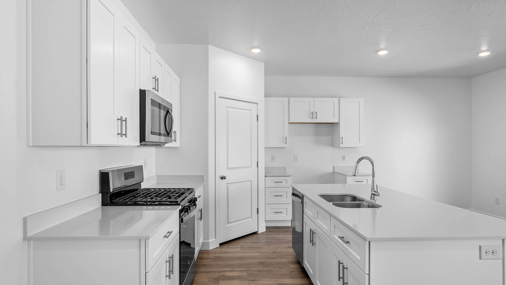 Kitchen space with kitchen island and white cabinets and countertops.
