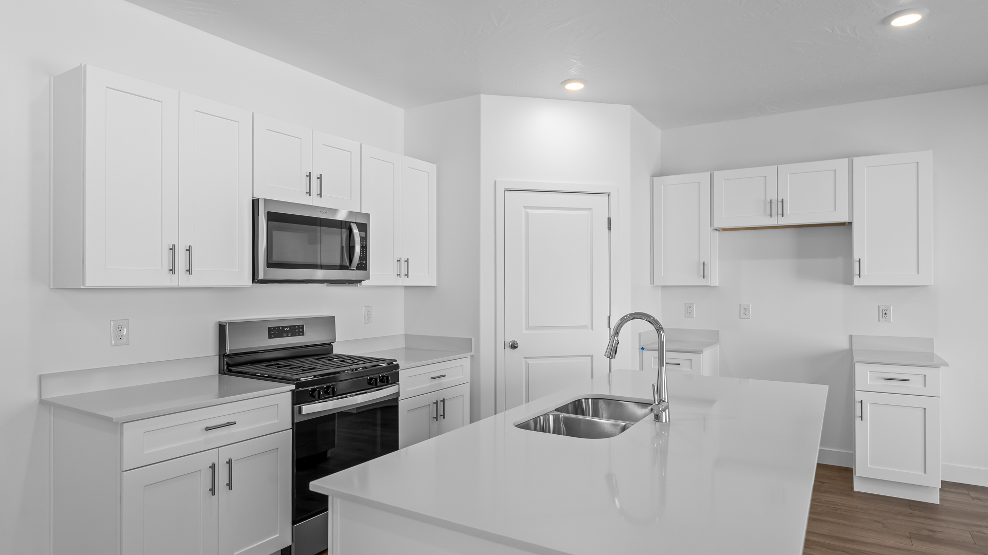 Kitchen space with kitchen island and white cabinets and countertops.