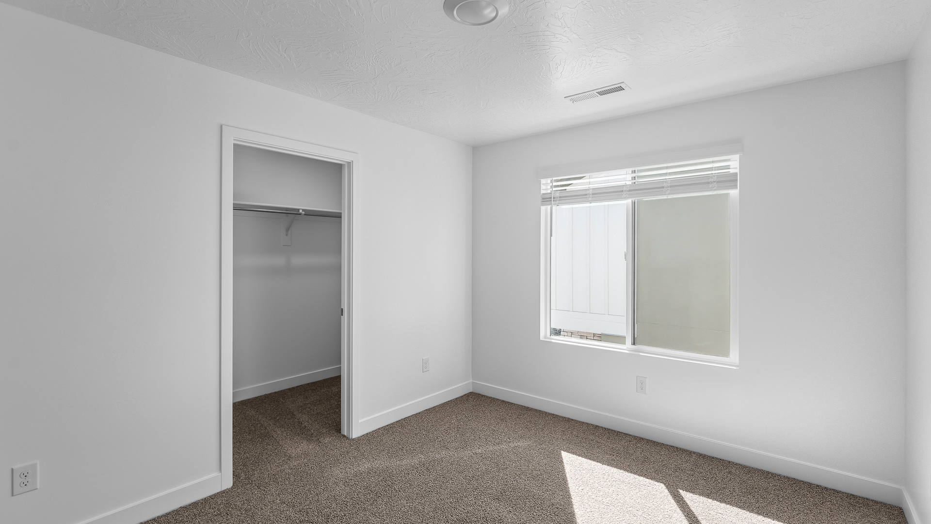 Bedroom with large window.Bedroom with large window.