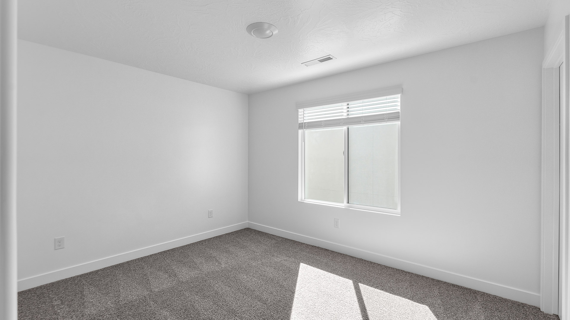 Bedroom with large window.
