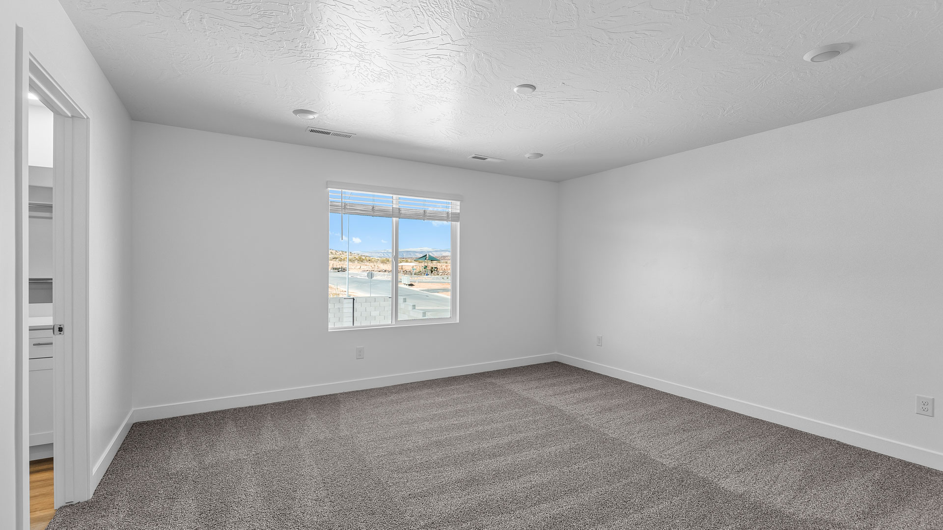 Primary bedroom with large window.