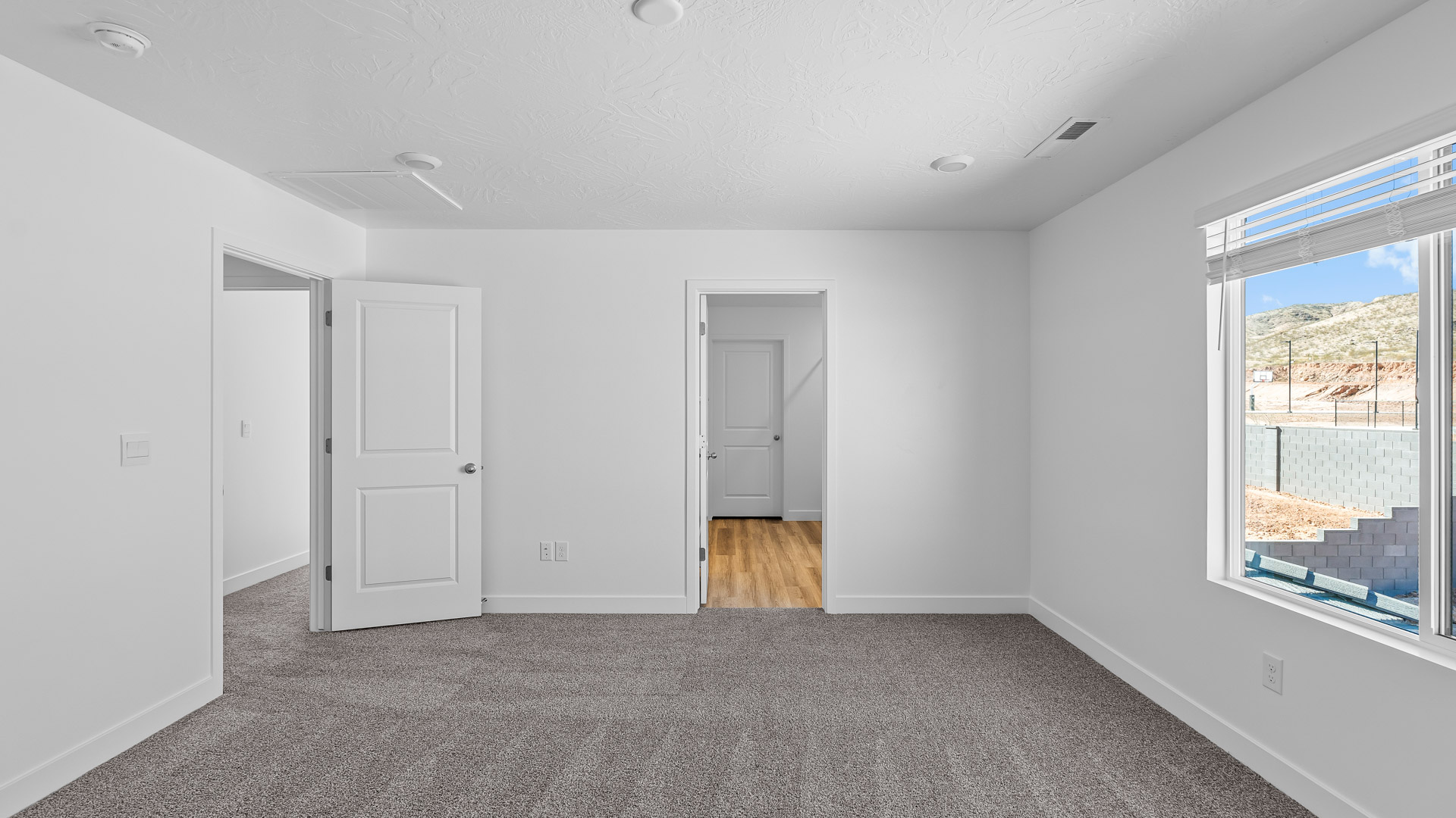 Primary bedroom with large window.